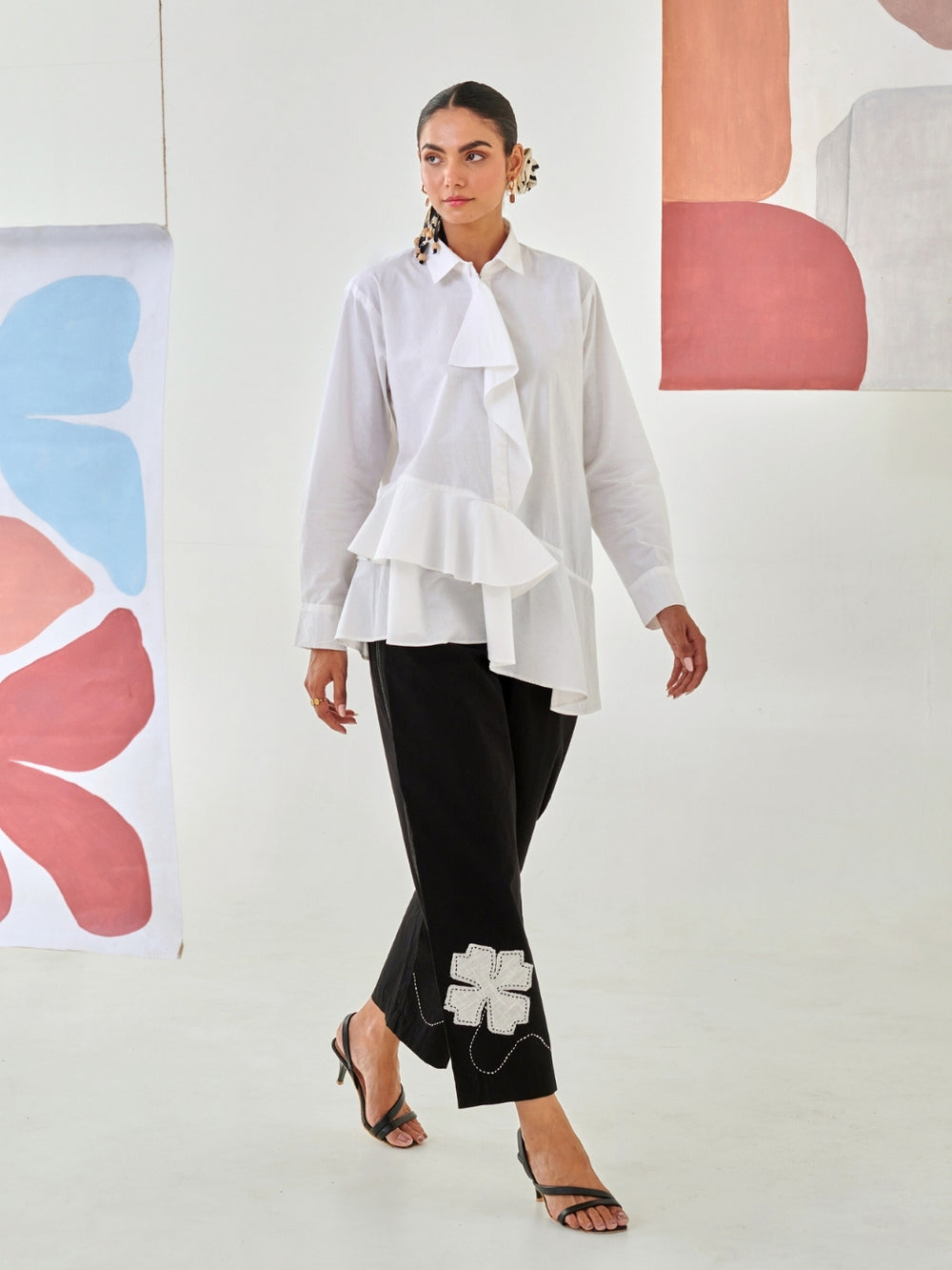 White Asymmetric Shirt Paired With Black Pants  With Floral Patch Detail